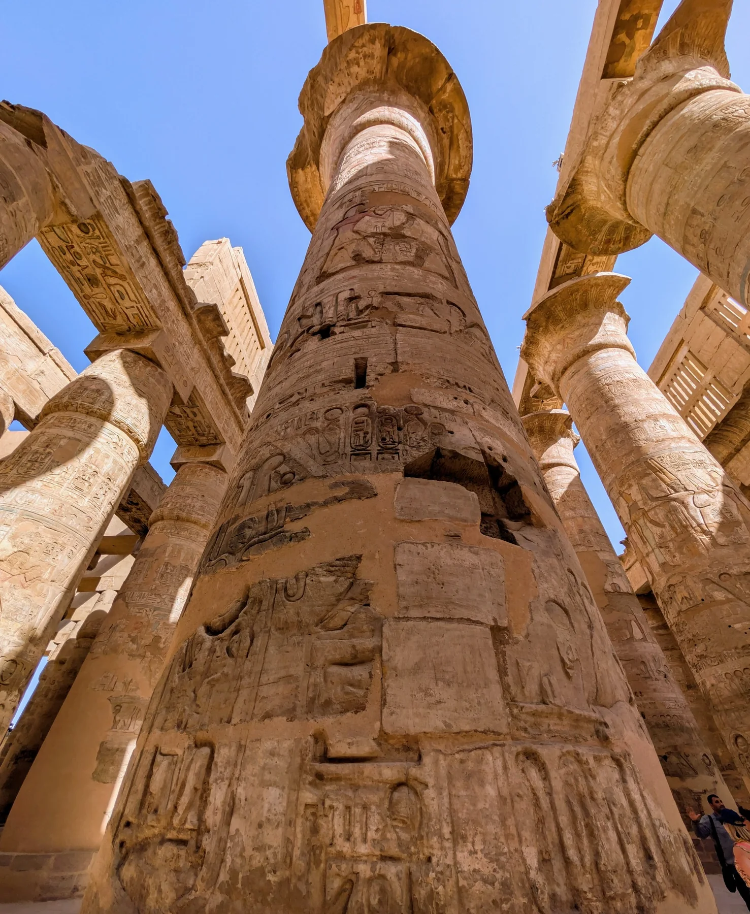 Looking upward between monumental carved stone columns in Egypt